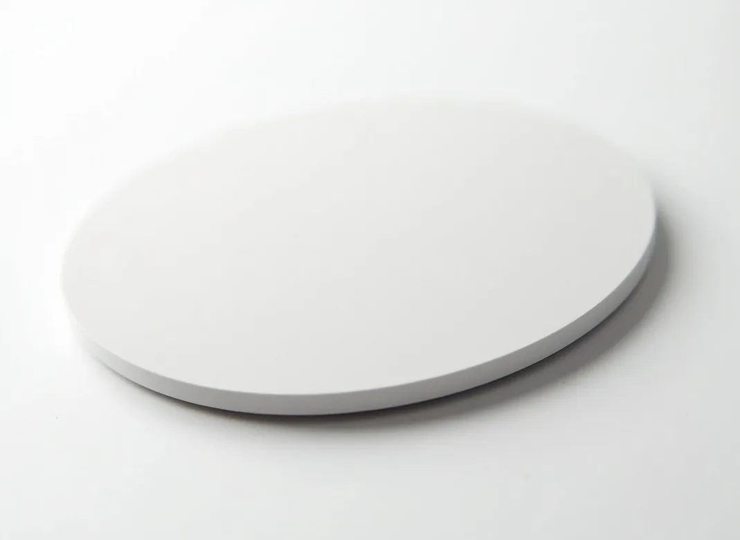 45-degree angle hero shot of small circular ceramic-coated PTFE mouse pad set in neat row
